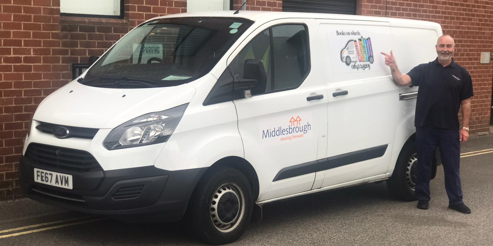 Middlesbrough's books on wheels driver standing beside the white books on wheels van